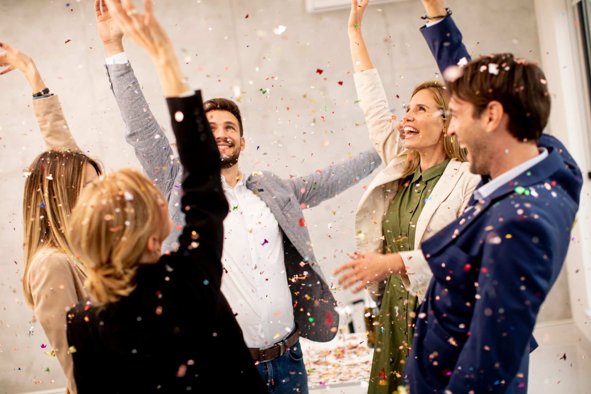 Group of business people celebrating and toasting with confetti